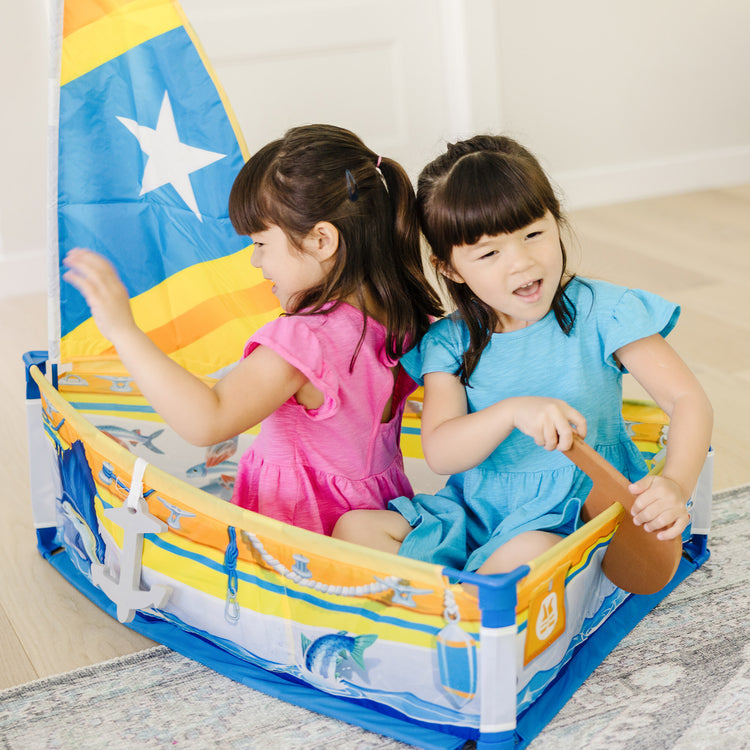 A kid playing with The Melissa & Doug Let’s Explore™ Sailboat Play Set