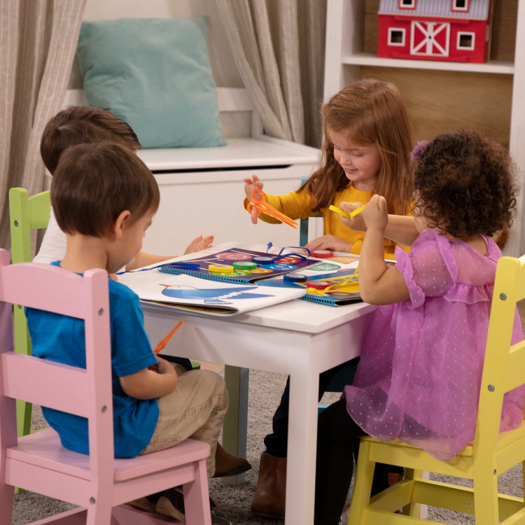 A kid playing with The Melissa & Doug Scissor Skills and Tape Activity Books Set