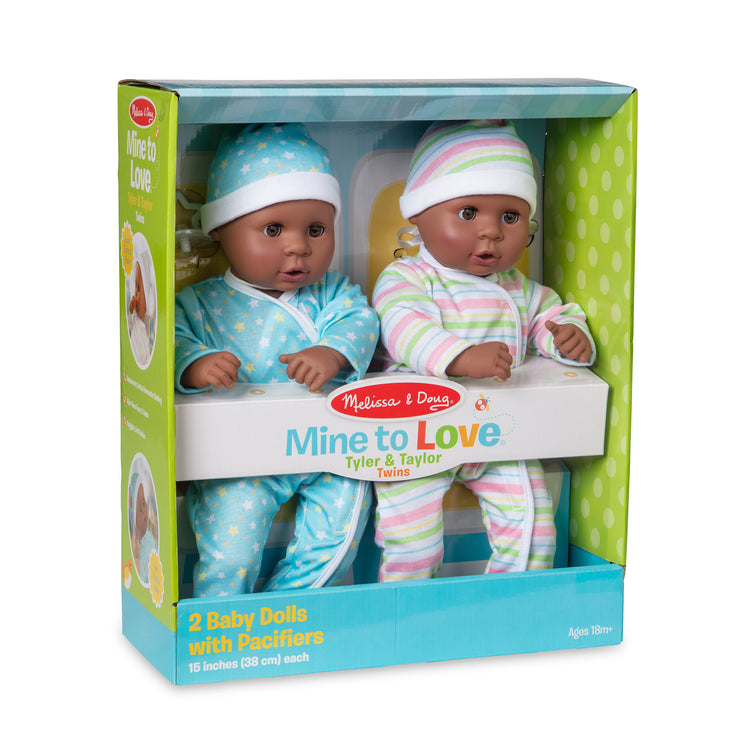 The front of the box for The Melissa & Doug Mine to Love Twins Tyler & Taylor 15” Dark Skin-Tone Boy and Girl Baby Dolls with Rompers, Caps, Pacifiers