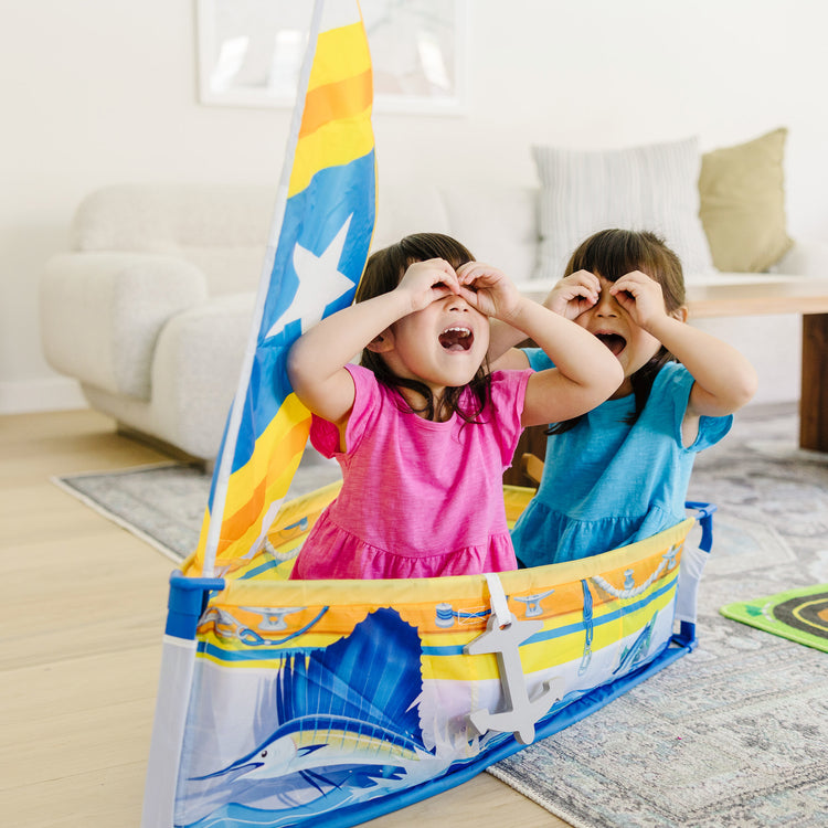 A kid playing with The Melissa & Doug Let’s Explore™ Sailboat Play Set