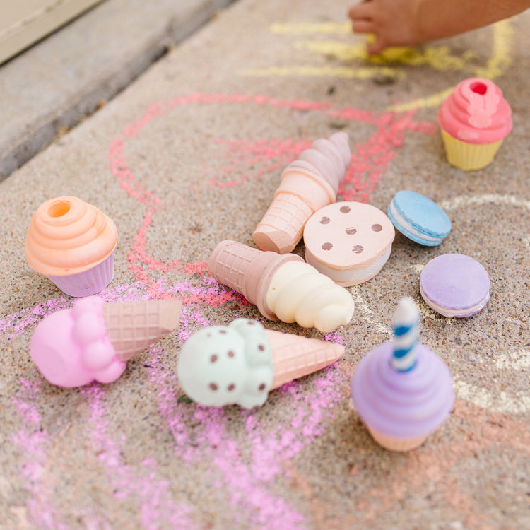 A kid playing with The Melissa & Doug Ice Cream & Cake Chalk Set