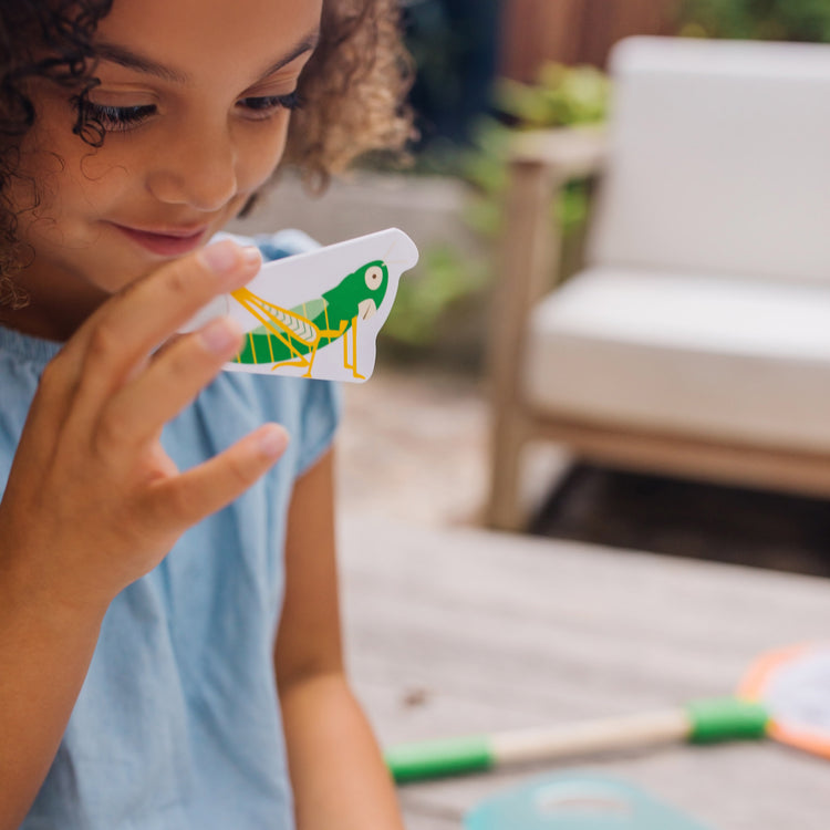 A kid playing with The Melissa & Doug Let’s Explore Critter Net Bug and Fish Catching Play Set (14 Pieces)