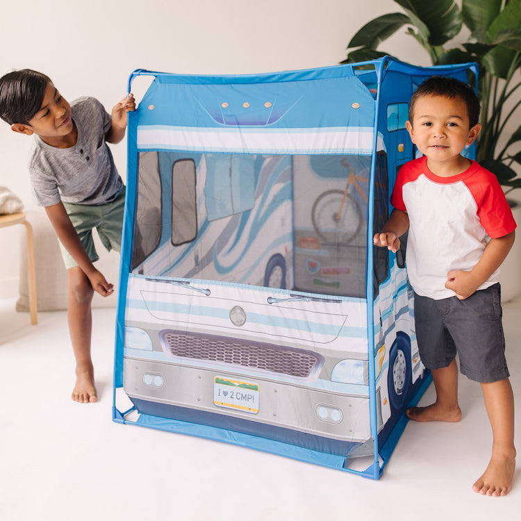 A kid playing with The Melissa & Doug Let’s Explore Camper Tent Play Set – 47” x 31” x 39” Assembled