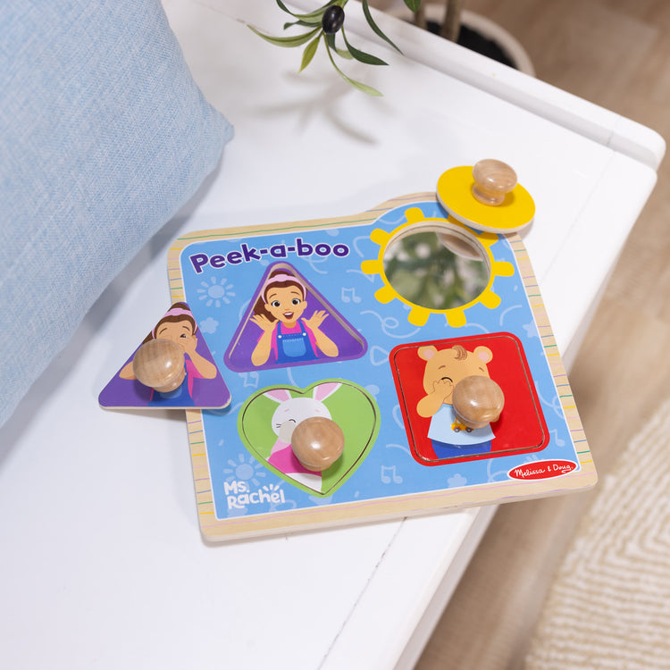 The loose pieces of The Melissa & Doug® Ms. Rachel™ Wooden Peek-a-Boo Jumbo Peg Puzzle, 4-Piece with Mirror, Toddler Toys for Boys and Girls Ages 1+ Years

