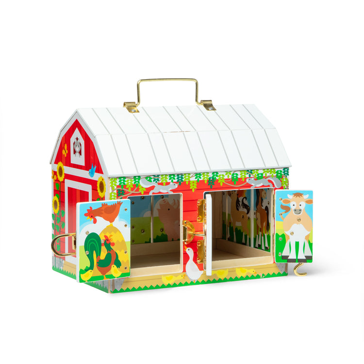 A kid playing with The Melissa & Doug Latches Wooden Activity Barn with 5 Doors, 4 Play Figure Farm Animals