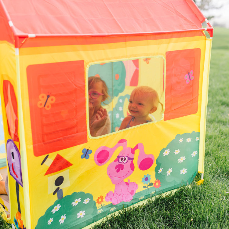 A kid playing with The Melissa & Doug Blue's Clues & You! Blue's House Play Tent