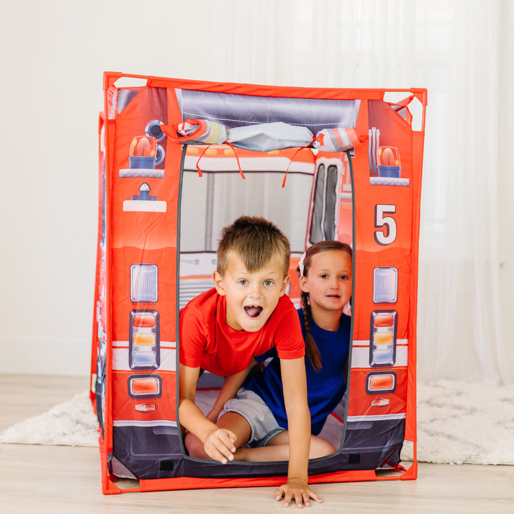 A kid playing with The Melissa & Doug Fire Truck Play Tent