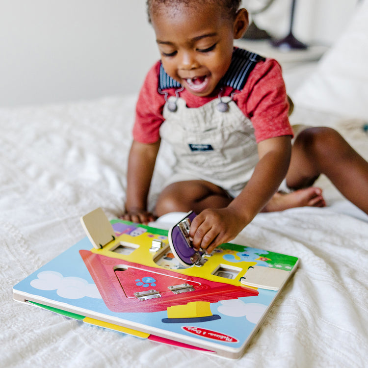 A kid playing with The Melissa & Doug Blue’s Clues & You! Wooden Activity Board with Clue Cards