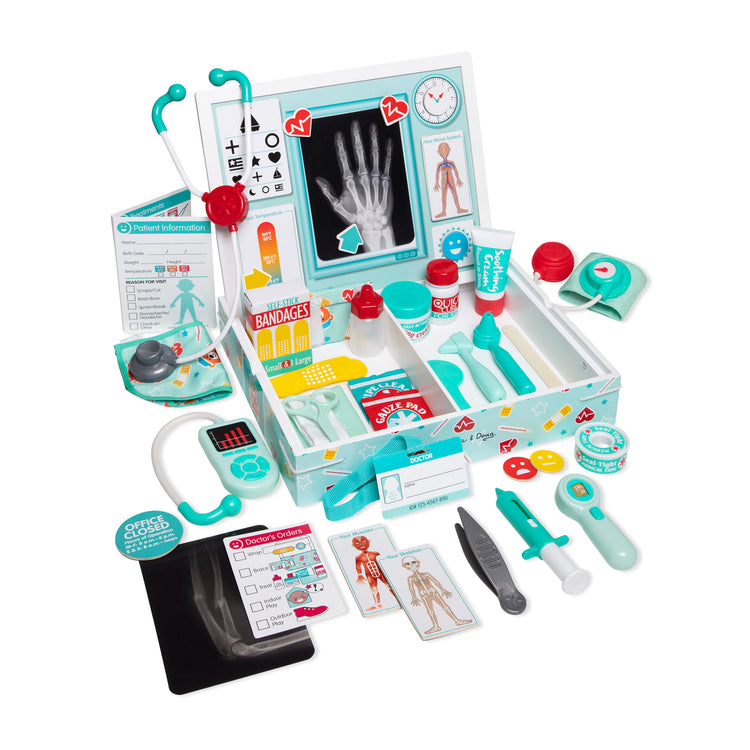 The loose pieces of The Melissa & Doug Deluxe Doctor’s Office Play Set with Take-Along Wooden Case and Magnetic Play Board – 46 Pieces