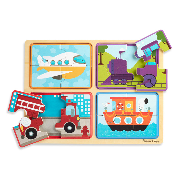 The loose pieces of The Melissa & Doug Natural Play Wooden Puzzle: Ready, Set, Go (Four 4-Piece Vehicle Puzzles)