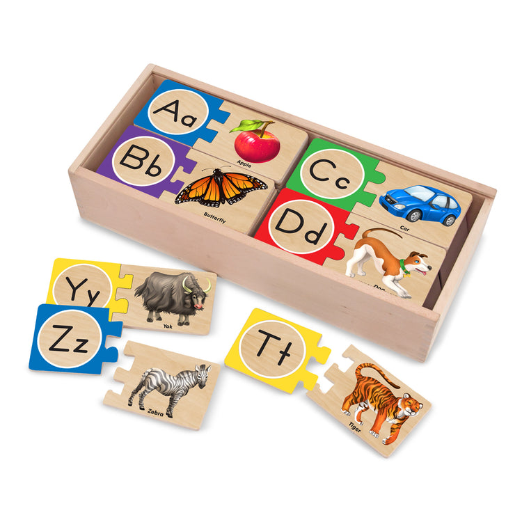 The loose pieces of The Melissa & Doug Self-Correcting Alphabet Wooden Puzzles With Storage Box (52 pcs)