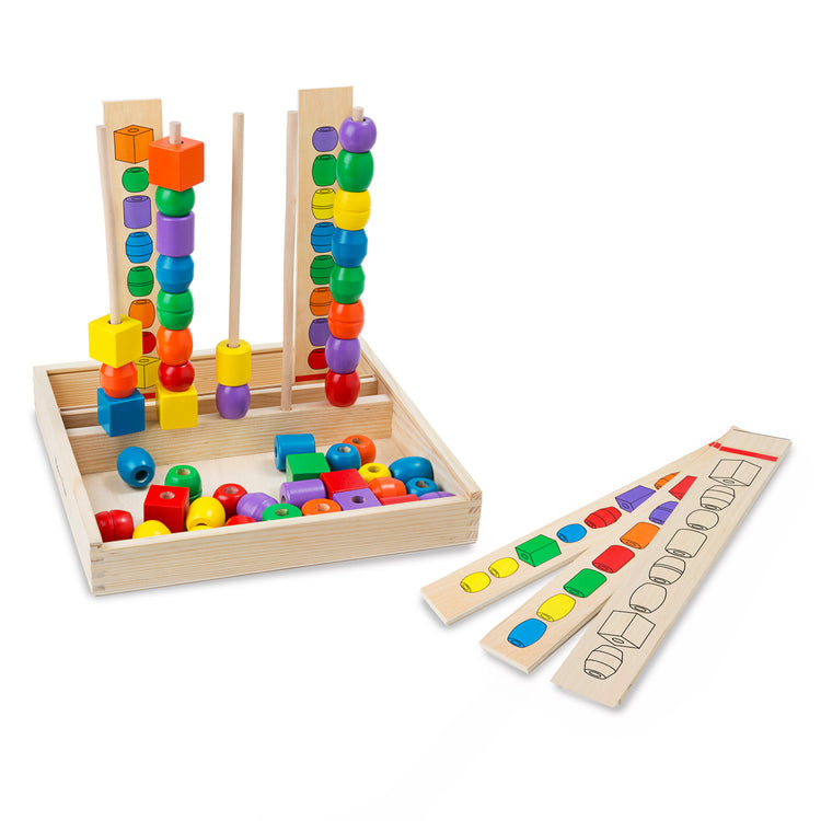 The loose pieces of The Melissa & Doug Bead Sequencing Set With 46 Wooden Beads and 5 Double-Sided Pattern Boards