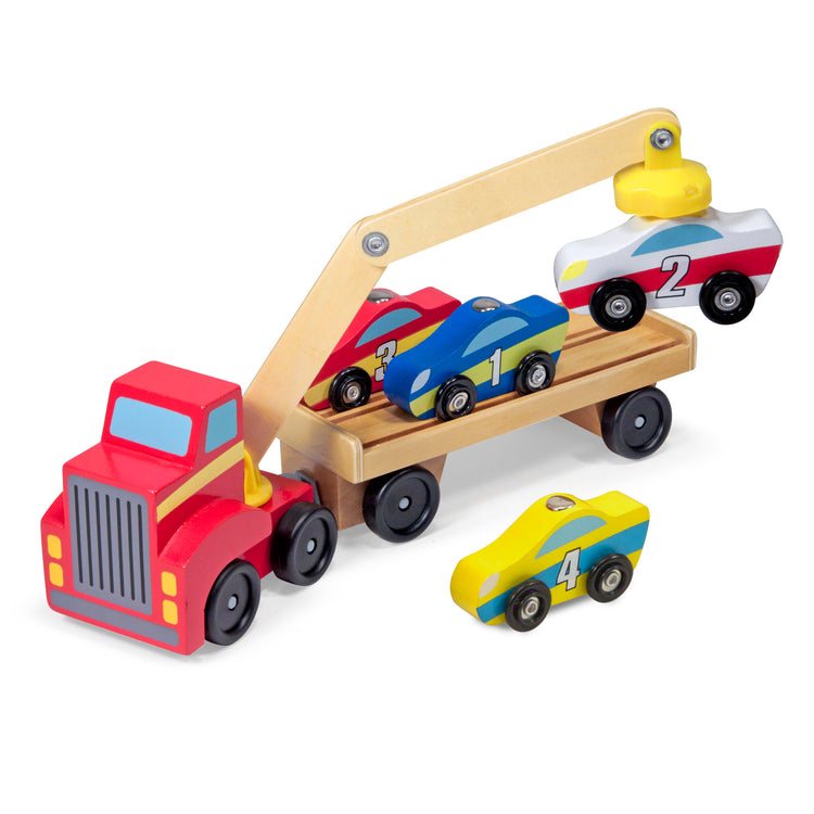 The loose pieces of The Melissa & Doug Magnetic Car Loader Wooden Toy Set With 4 Cars and 1 Semi-Trailer Truck