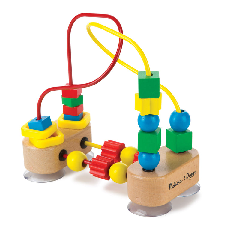 The loose pieces of The Melissa & Doug First Bead Maze - Wooden Educational Toy for Floor, High Chair, or Table