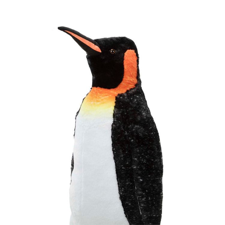 The loose pieces of The Melissa & Doug Giant Lifelike Plush Emperor Penguin Standing Stuffed Animal (3.4 Feet Tall)