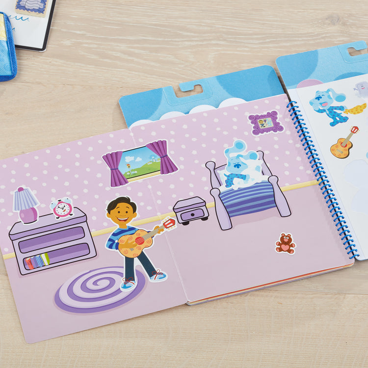 A playroom scene with The Melissa & Doug Blue's Clues & You! Restickable Stickers Pad - Places Blue Loves