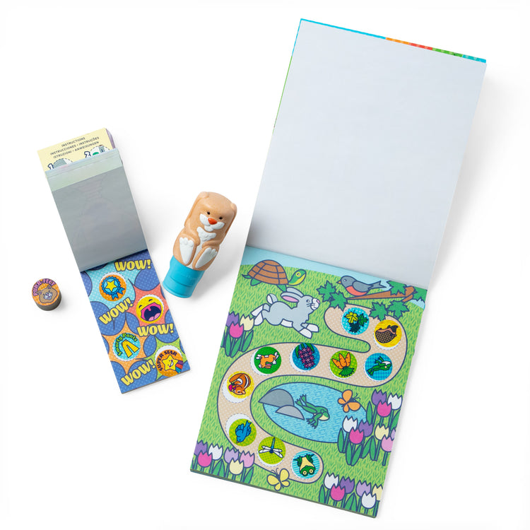 The loose pieces of The Melissa & Doug Sticker WOW!™ Bunny Bundle: 24-Page Activity Pad, Sticker Stamper, 500 Stickers, Mini Pad, Arts and Crafts Fidget Toy Collectible Character