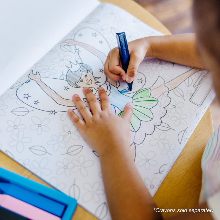 A kid playing with The Melissa & Doug Jumbo 50-Page Kids' Coloring Pad - Horses, Hearts, Flowers, and More