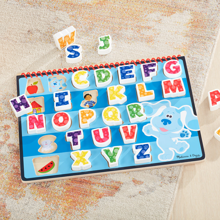 A playroom scene with The Melissa & Doug Blue's Clues & You! Wooden Chunky Puzzle - Alphabet (26 Pieces)
