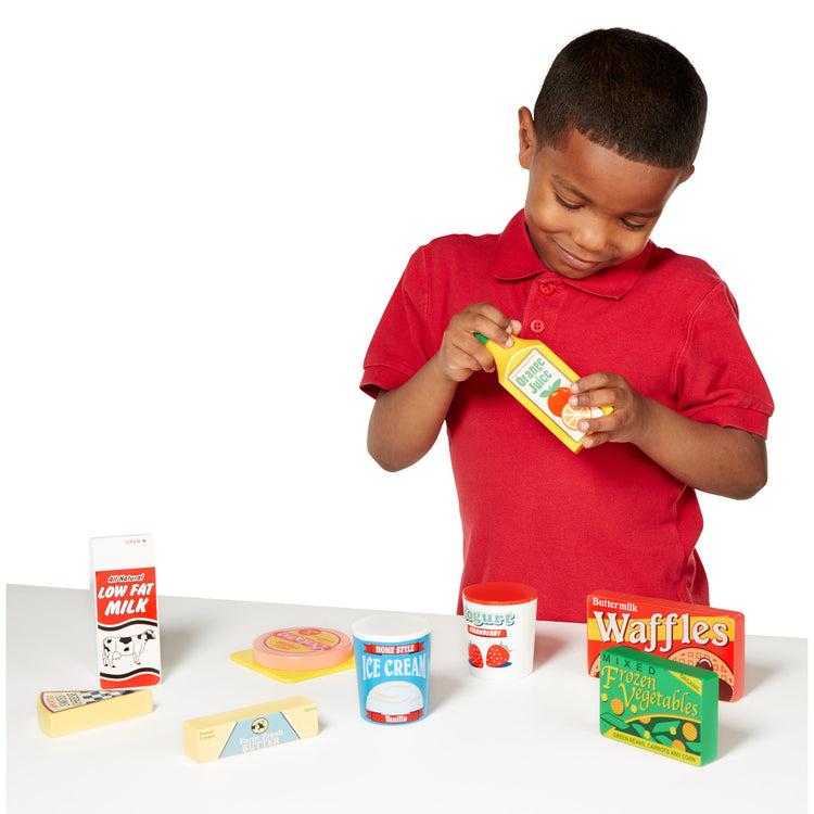 A child on white background with The Melissa & Doug Fridge Food Wooden Play Food Set - 9 Pieces