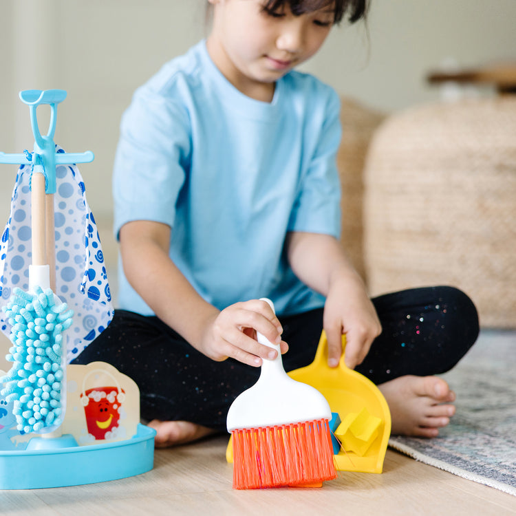 A kid playing with The Melissa & Doug Blue’s Clues & You! Clean-Up Time Play Set