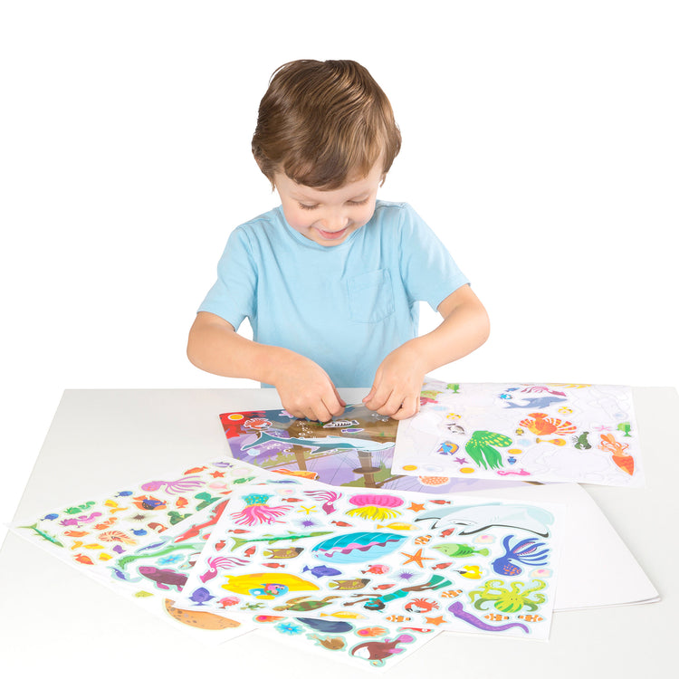 A child on white background with The Melissa & Doug Reusable Sticker Pad Bundle - Jungle, Farm & Under the Sea