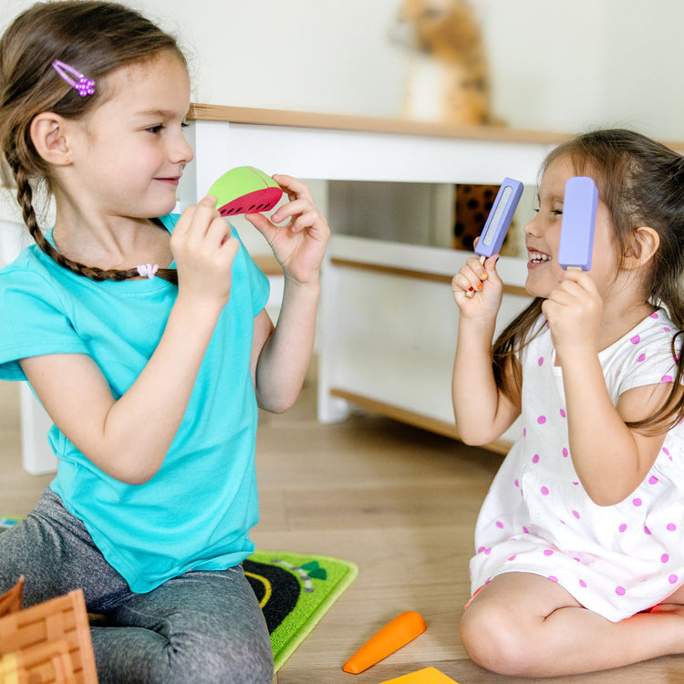 A kid playing with The Melissa & Doug Blue’s Clues & You! Share with Blue Picnic Play Set with Hand Puppet