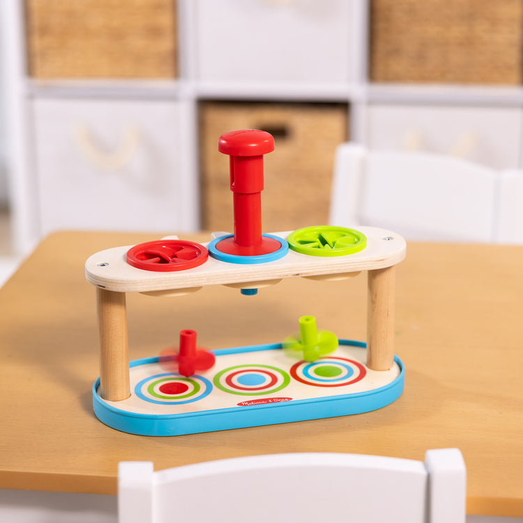 A playroom scene with The Melissa & Doug Match & Push Spinning Tops Developmental Skills Toy for Girls and Boys 2+ 