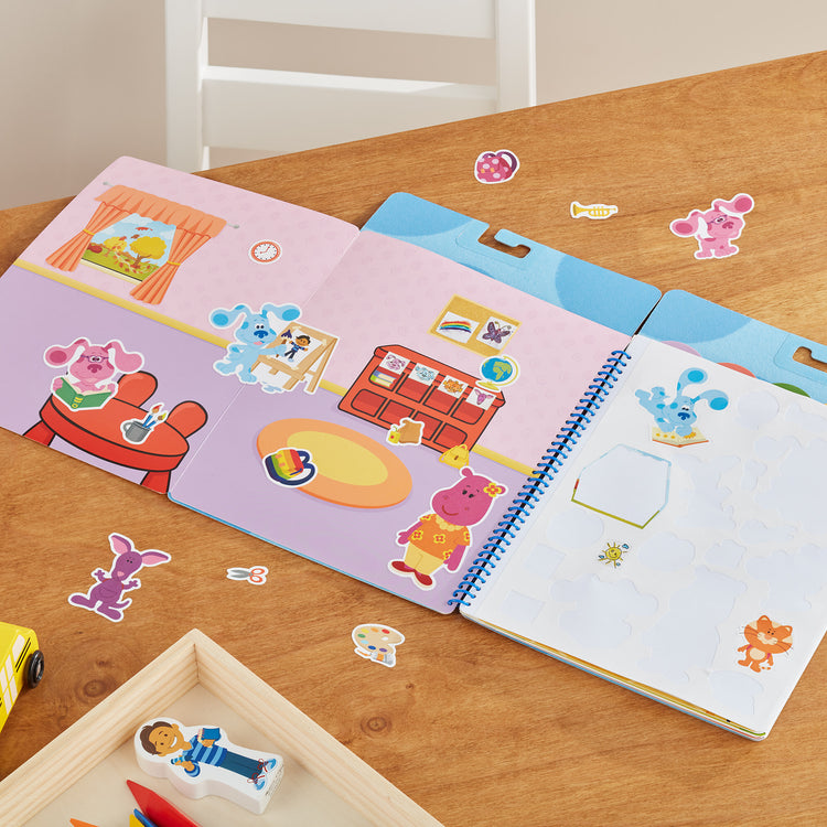 A playroom scene with The Melissa & Doug Blue's Clues & You! Restickable Stickers Pad - Places Blue Loves
