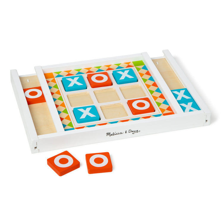 The loose pieces of The Melissa & Doug Wooden Tic-Tac-Toe Board Game with 10 Self-Storing Wooden Game Pieces (12.5” W x 8.5” L x 1.25” D)