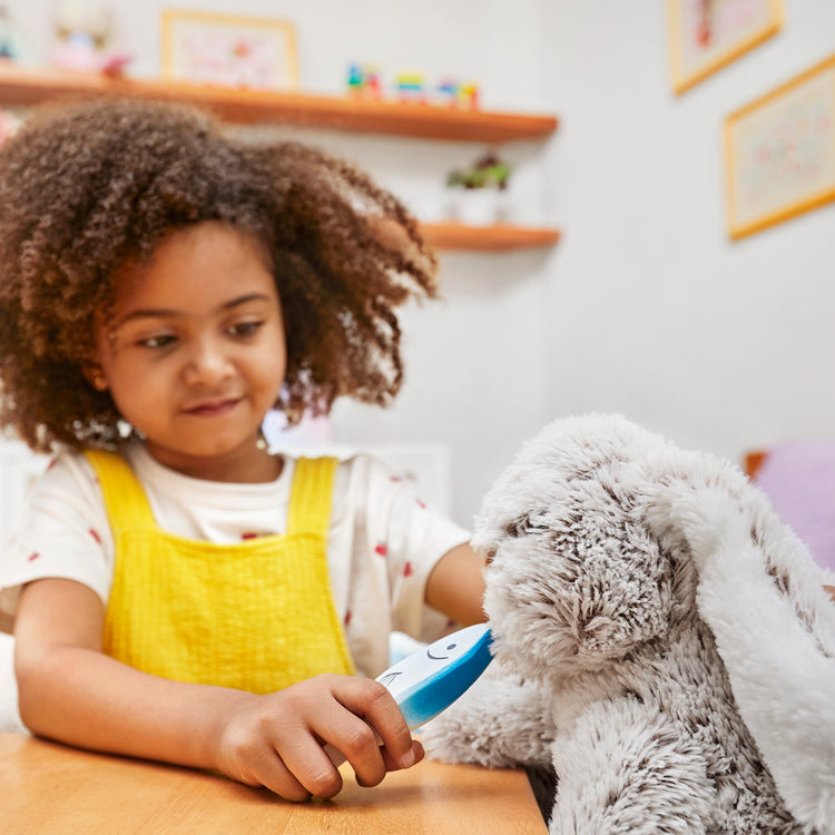 A kid playing with The Melissa & Doug Burrow Bunny Rabbit Stuffed Animal (9 inches)