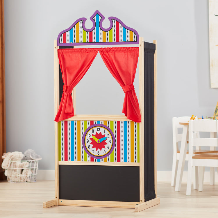 A playroom scene with The Melissa & Doug Deluxe Puppet Theater - Sturdy Wooden Construction