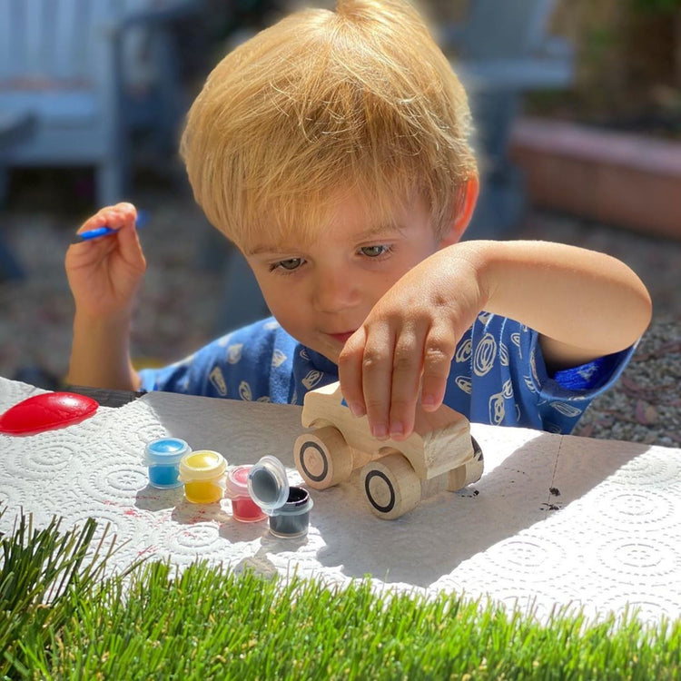 A kid playing with The DYO Bundle - Monster Truck & Train