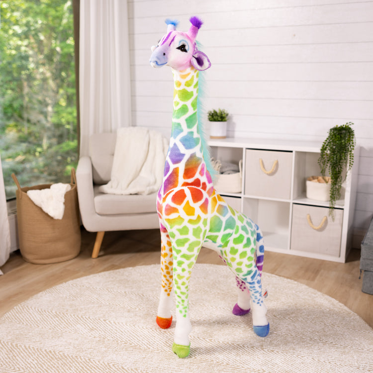 A playroom scene with The Melissa & Doug Rainbow Giraffe Lifelike Plush