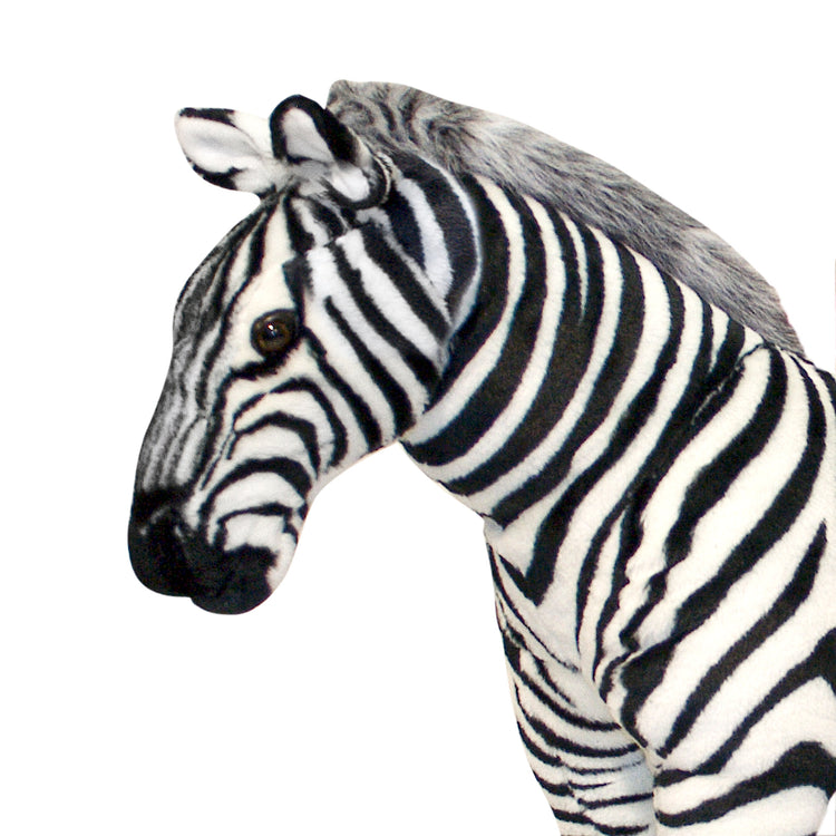 A kid playing with The Melissa & Doug Giant Striped Zebra - Lifelike Stuffed Animal (nearly 3 feet tall)