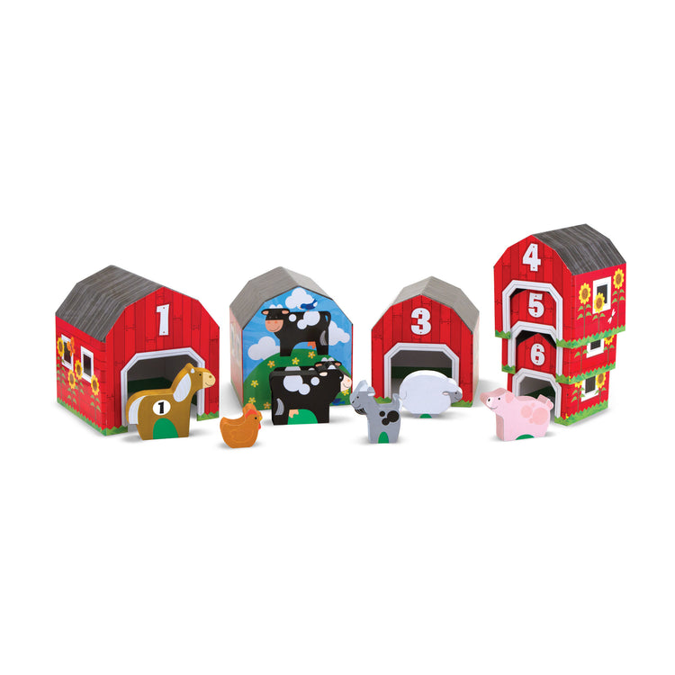 The loose pieces of The Melissa & Doug Nesting and Sorting Barns and Animals With 6 Numbered Barns and Matching Wooden Animals