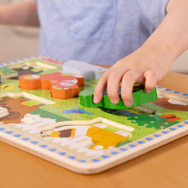 A kid playing with The Melissa & Doug Pets Wooden Chunky Puzzle (8 pcs)