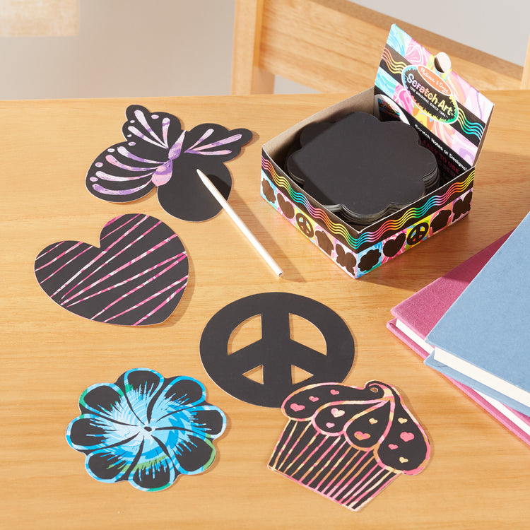 A playroom scene with The Melissa & Doug Scratch Art® Box of 125 Friendship-Themed Shaped Notes in Desktop Dispenser (Approx. 3.5” x 3.5” Each Note)