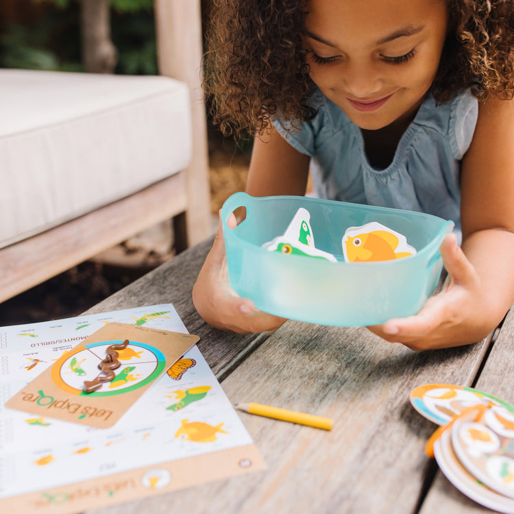 A kid playing with The Melissa & Doug Let’s Explore Critter Net Bug and Fish Catching Play Set (14 Pieces)