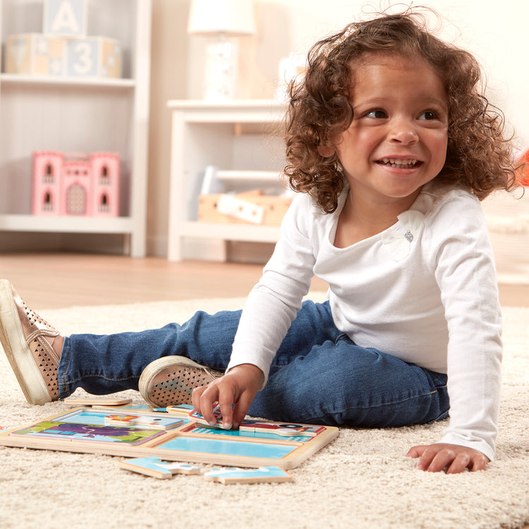 A kid playing with The Melissa & Doug Natural Play Wooden Puzzle: Ready, Set, Go (Four 4-Piece Vehicle Puzzles)