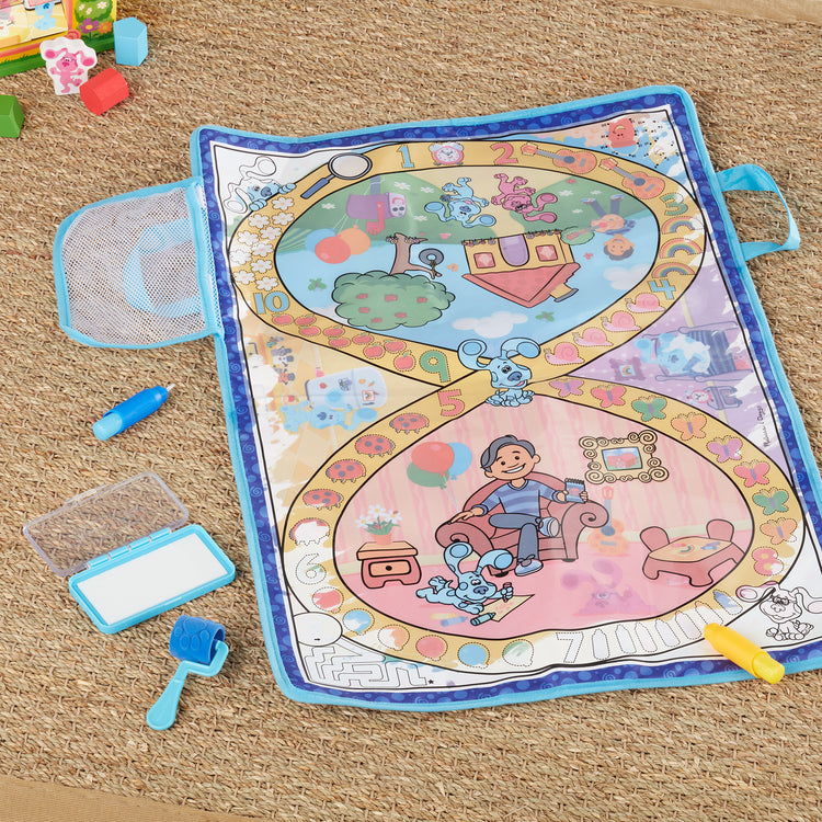 A kid playing with The Melissa & Doug Blue's Clues & You! Water Wow! Activity Mat (20 Inches x 30 Inches) With Reusable Water Reveal Surface