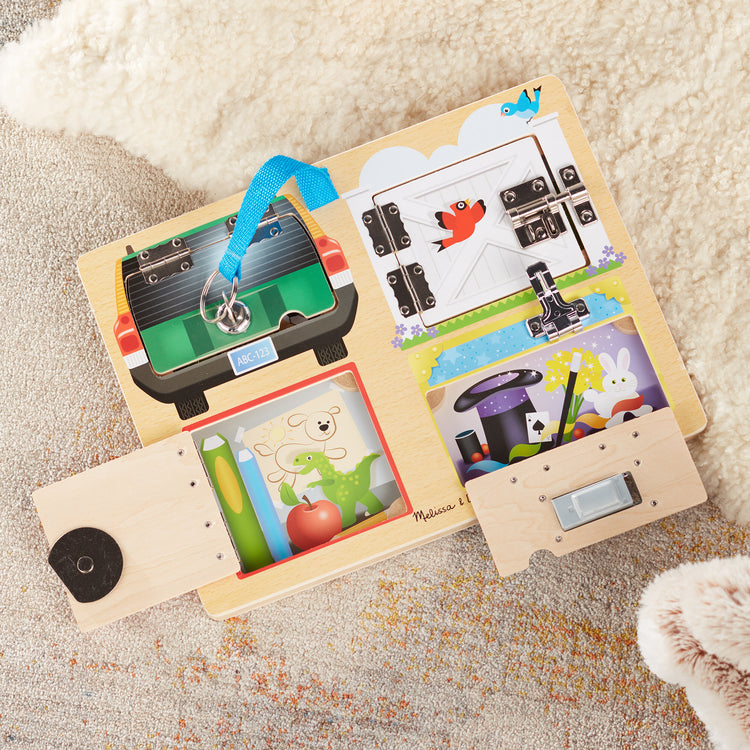 A playroom scene with The Melissa & Doug Locks and Latches Board Wooden Educational Toy