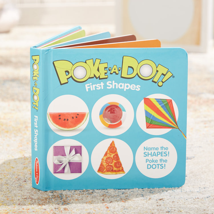 A playroom scene with The Melissa & Doug Children’s Book – Poke-a-Dot: First Shapes (Board Book with Buttons to Pop)