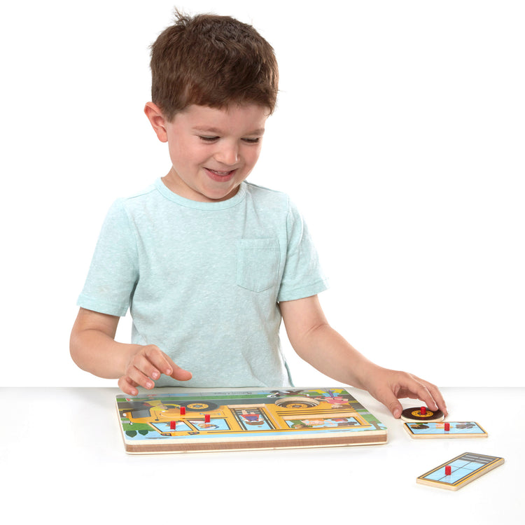 A child on white background with The Melissa & Doug The Wheels on the Bus Sound Puzzle