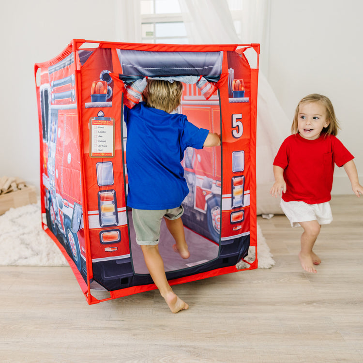 A kid playing with The Melissa & Doug Fire Truck Play Tent