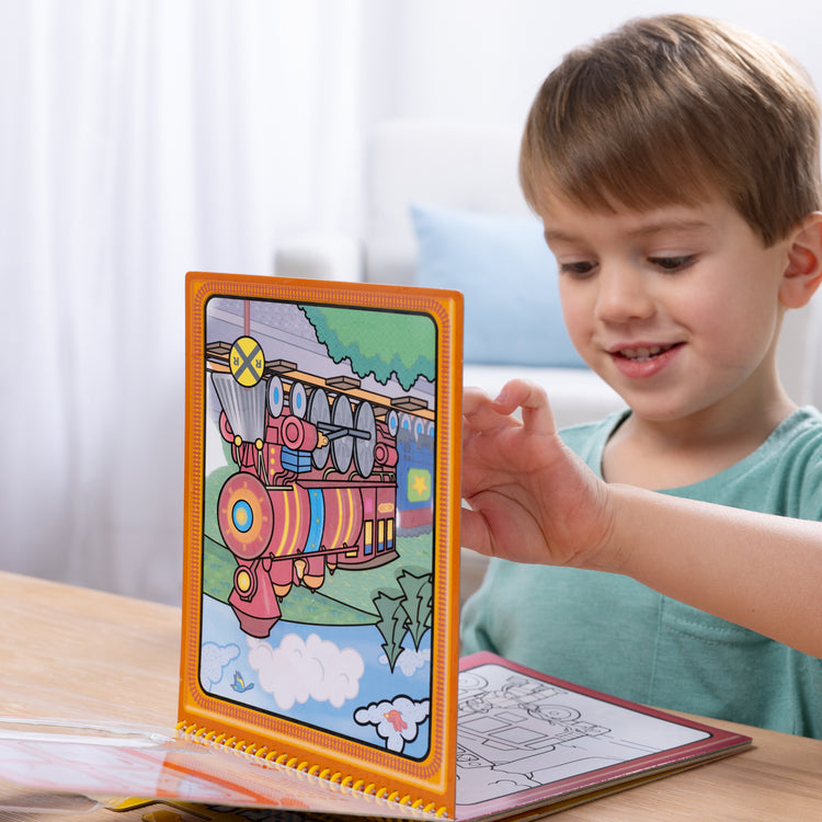 A kid playing with The Melissa & Doug On the Go Water Wow! Reusable Water-Reveal Activity Pad - Vehicles