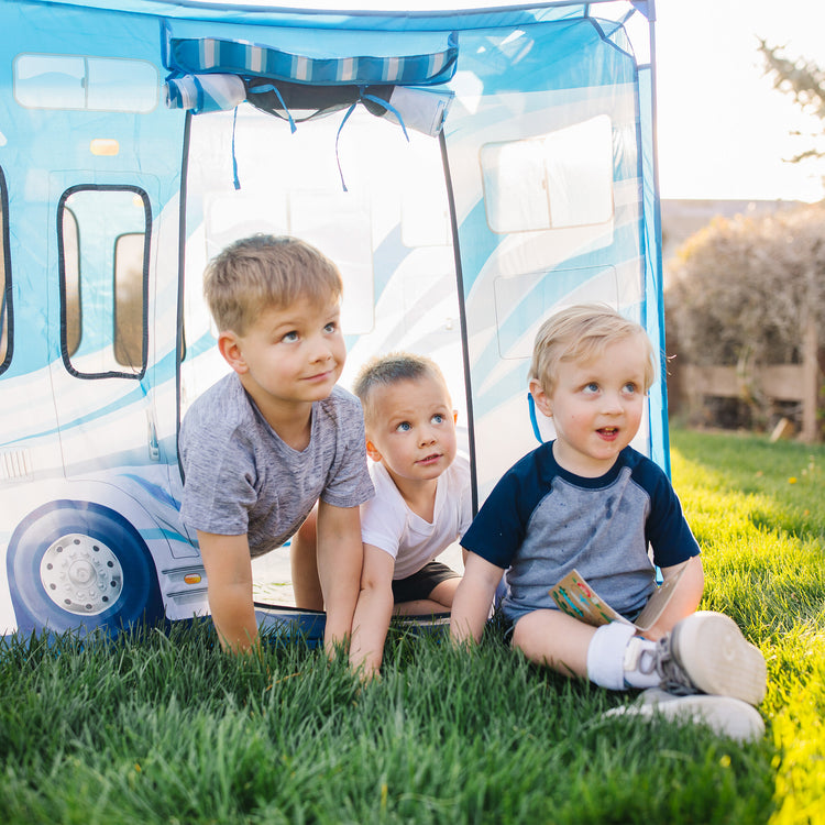 A kid playing with The Melissa & Doug Let’s Explore Camper Tent Play Set – 47” x 31” x 39” Assembled