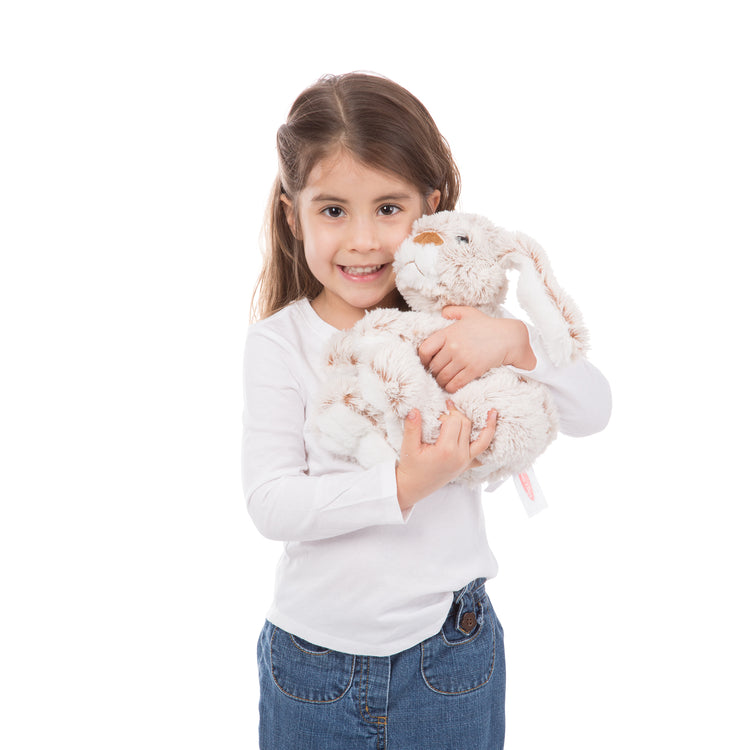 A kid playing with The Melissa & Doug Burrow Bunny Rabbit Stuffed Animal (9 inches)