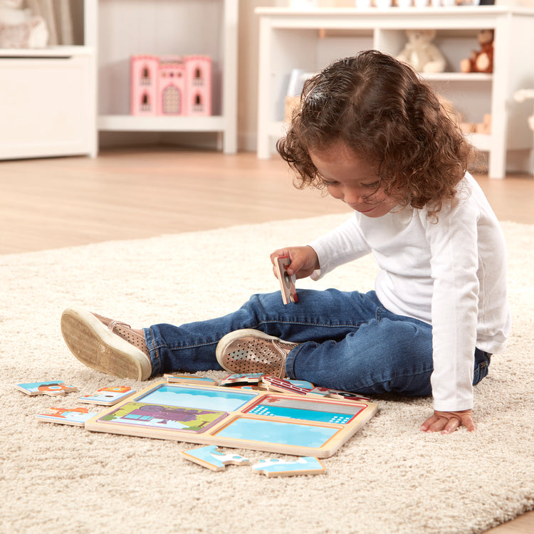 A kid playing with The Melissa & Doug Natural Play Wooden Puzzle: Ready, Set, Go (Four 4-Piece Vehicle Puzzles)