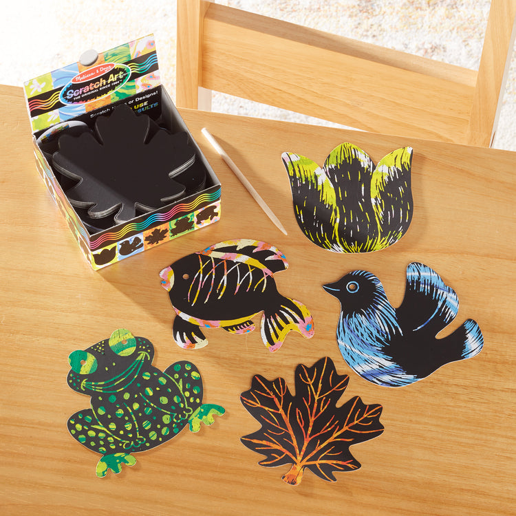 A playroom scene with The Melissa & Doug Scratch Art® Box of 125 Nature-Themed Shaped Notes in Desktop Dispenser (Approx. 3.5” x 3.5” Each Note)